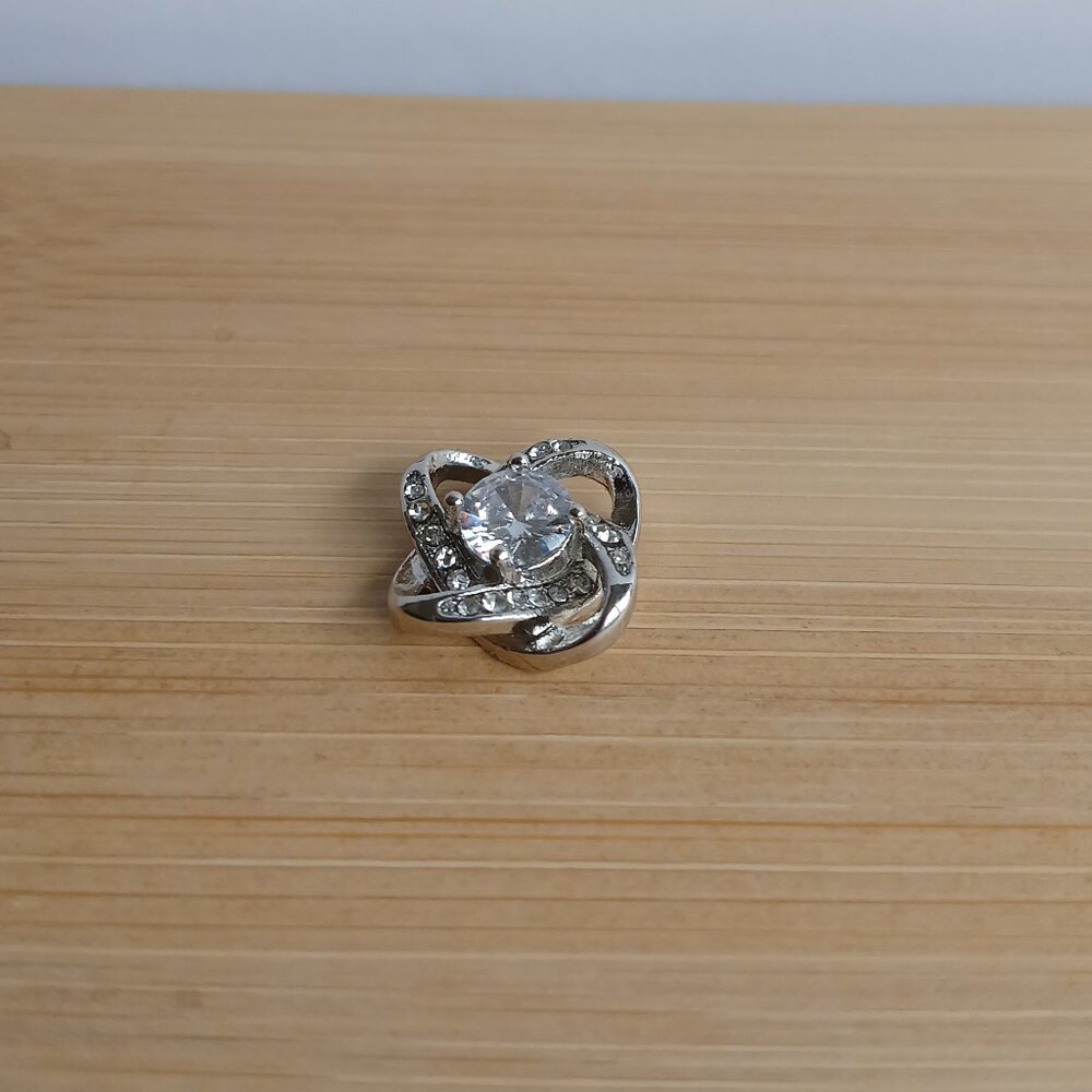 Love knot silver tone pendant only --.5" across